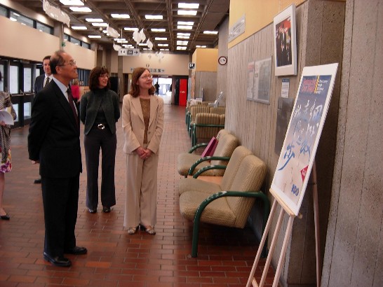 Taiwan Representative Dr. David Lee visits the exhibition and explains the historic meaning of each picture to Helene Carrier, Director of Morisset Library.