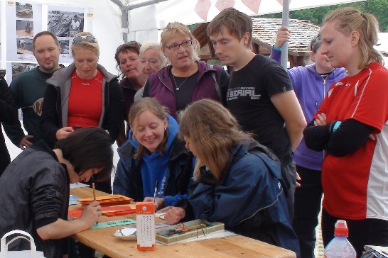 文宣攤位示範書法，吸引德籍人士駐足圍觀並索取紀念品。