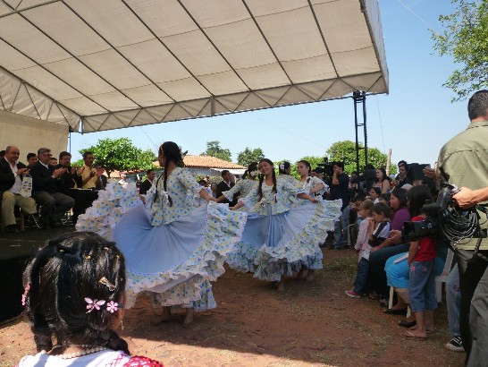 Durante el acto de inauguracion de las viviendas populares, unas jovenes ofrecen bailes tradicionales del pais a las autoridades