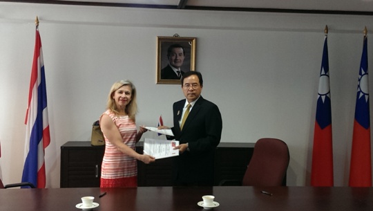 Amb. Henry M.J. Chen and Mrs. Sally Thompson, Executive Director of The Border Consortium (TBC) are exchanging the partnership agreements.