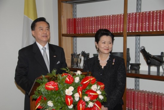 Ambassador and Mrs Wang pose in front of the podium.