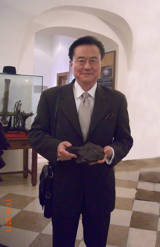Ambassador Wang holds a piece of meteorite.