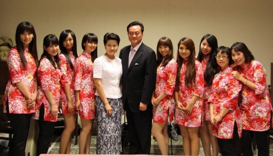 Ambassador and Mrs. Wang with young talented female musicians wearing traditional Hakka clothes