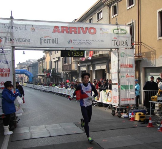 Taiwanese athlete Wang Chiu-Chun crosses the finishing line (he came in third)