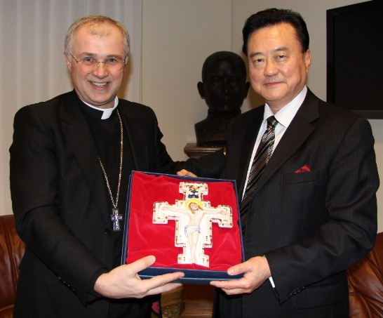 Bishop Giuliodori and AbassadorWang hold a gift that the Vatican official brought all the way from Macerata.