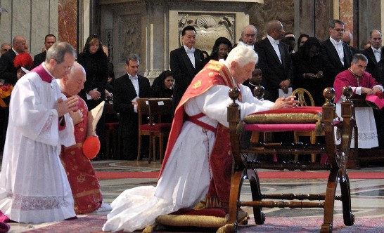 The Holy Father kneels in silent prayer at the start of the Liturgy of the Lord’s Passion (Ambassador and Mrs. Wang with the Diplomatic Corps are in the left side of the Holy Father)