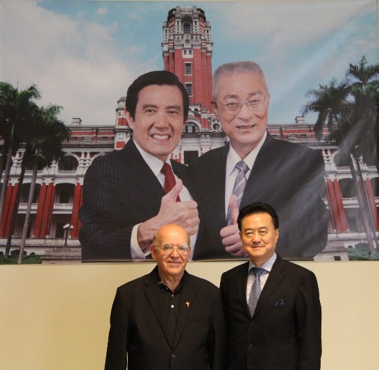 Ambassador Wang (1st from right) with Fr. Giuseppe Didone (1st from left) pose under the poster of newly re-elected President Ma and Vice-president Wu.