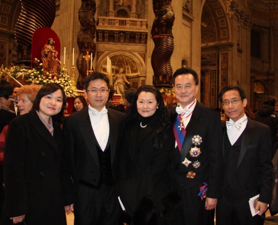 Ambassador and Mrs. Larry Yu-yuan Wang (2nd and 3rd from right) with the Embassy staff in front of the Altar of the Chair.