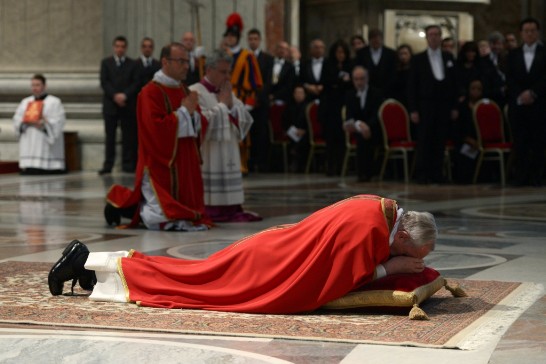 Pope Francis lies prostrate on the floor in silent prayer at the start of the Liturgy of the Lord’s Passion (Ambassador Wang with the Diplomatic Corps stands to the upper right side of the Holy Father).