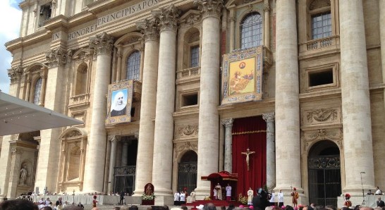 A view of the marble façade of St. Peter’s Basilica displaying the portraits of the new saints.