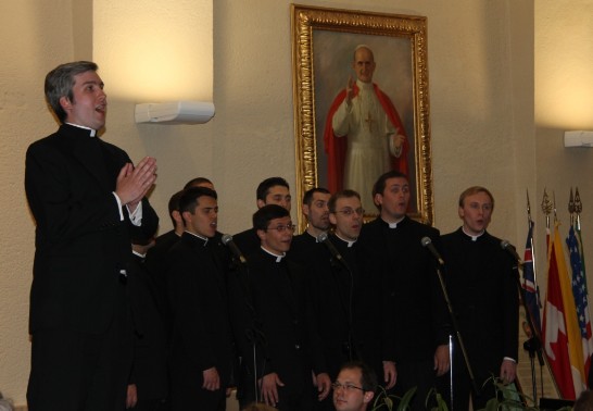 A solo singer accompanied by a chorus of seminarians and priests sings “Torna a Surriento.”
