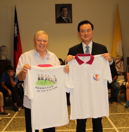 Ambassador Larry Wang (1st from right) holds a t-shirt commemorating the 400th year anniversary of the death of St. Camillus Del Lellis given to him by Fr. Felice Chech (1st from left).