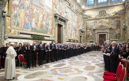 The Diplomatic Corps stand and greet Pope Francis who enters the Regia Hall.