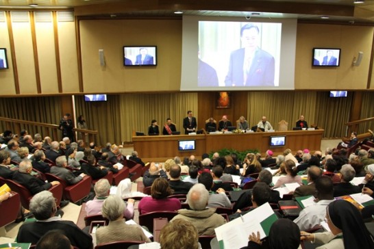 During the International Conference, Ambassador Larry Wang addresses the audience (his image is on the screen).