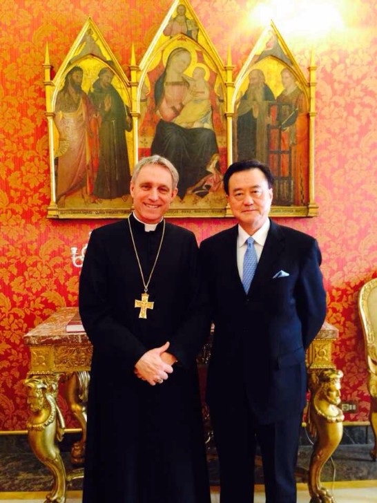 Archbishop Georg Gänswein poses with Ambassador Larry Wang inside the Prefecture of the Papal Household.