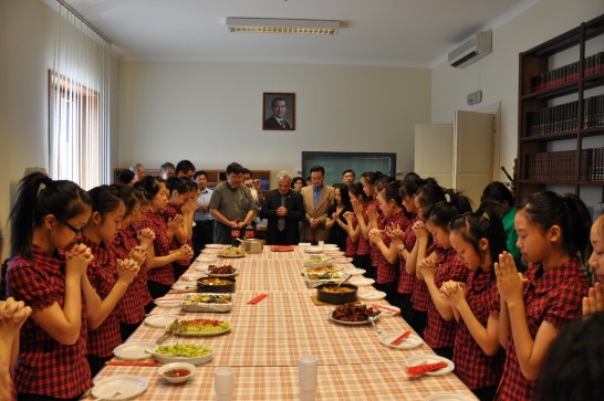 Fr. Gian Carlo MICHELINI(middle) says prayer before lunch at the Embassy 