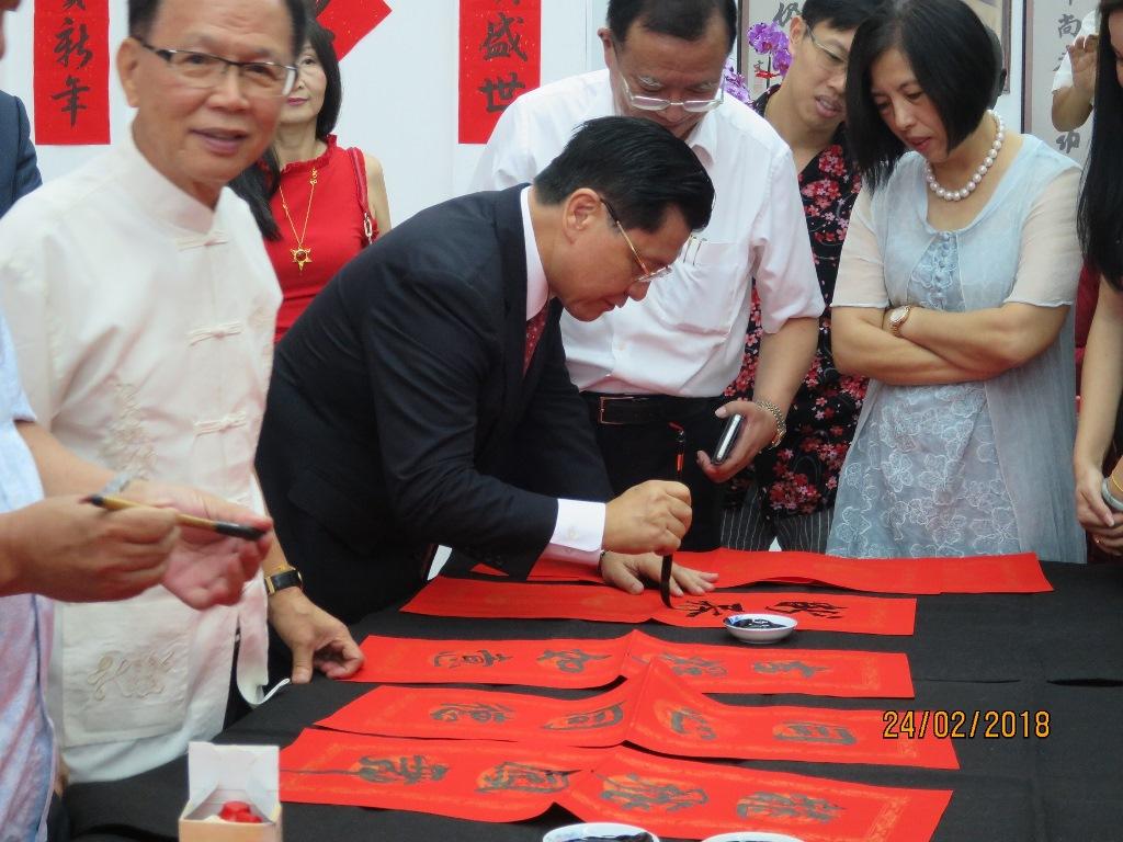 Representative Liang writing his Chinese new year greetings.