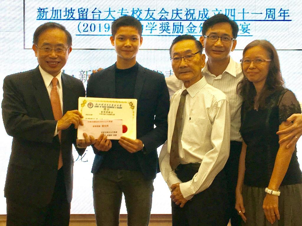 Director Jerry K. H. Chen (first from left) presents a special award to the top scorer of the high school category as the latter’s family members looked on (2019/06/01)